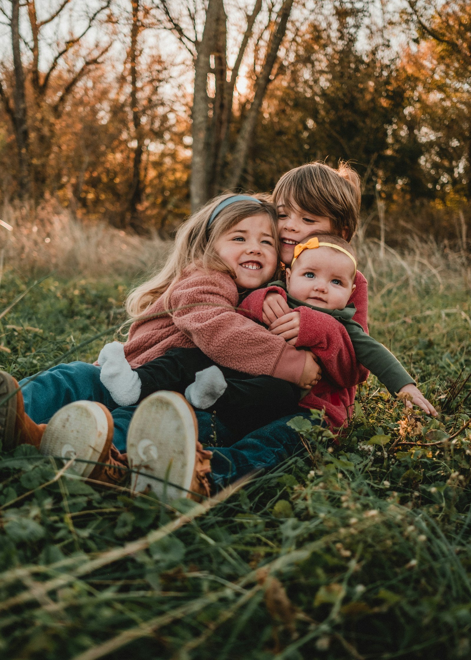 Two children sitting together on the grass